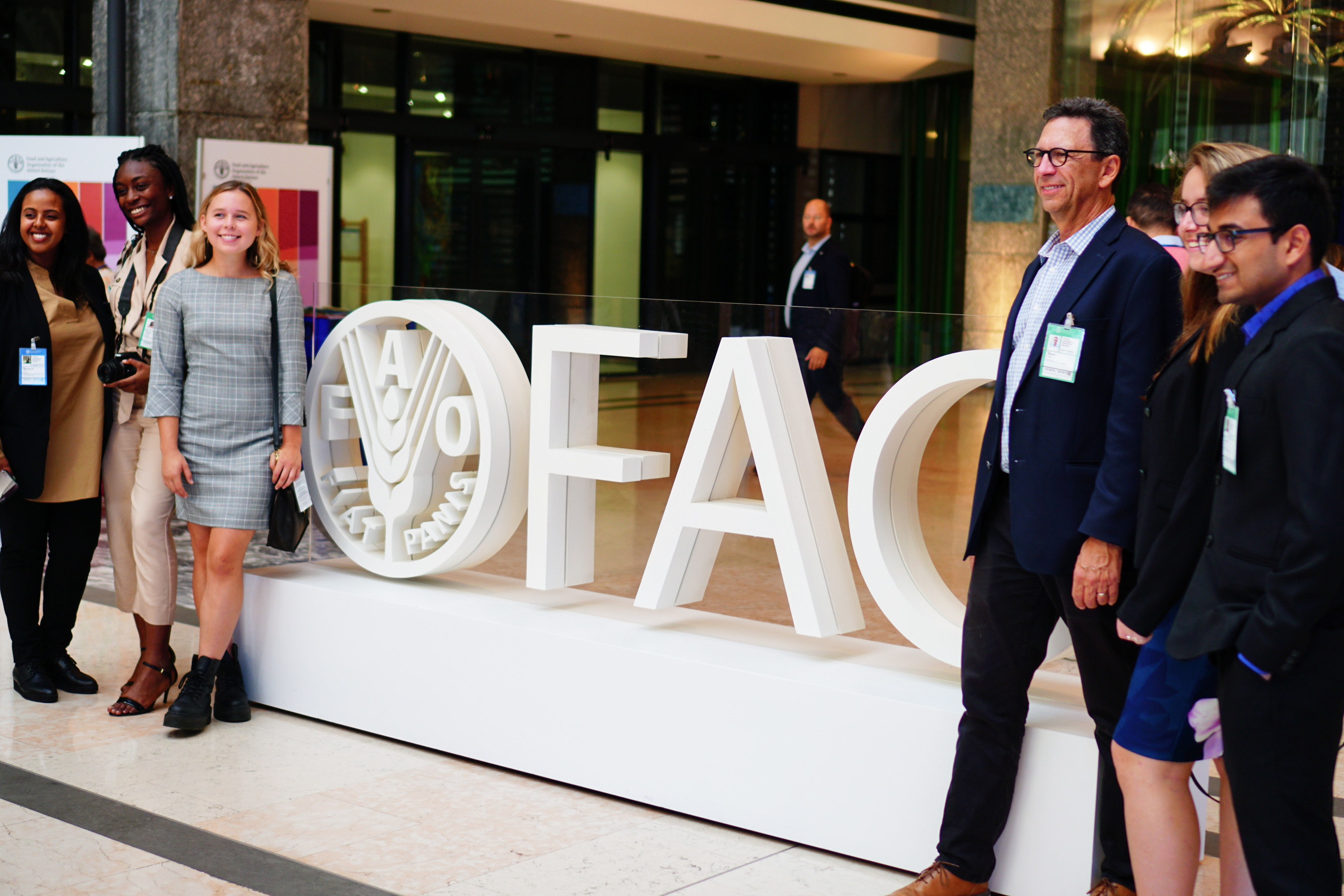 In the entrance hall of FAO headquarters in Rome, our group gathered for a photo op. From left: Ahdi Mohammed of the FAO Liaison Office for North America, Marisa Umeh, Lindsay Eberhart, Planet Forward Founder Frank Sesno, Matilda Kreider, and Rohan Agrawal.
